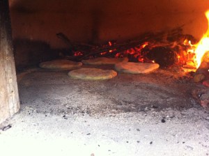 Firing a batch in the oven, with the fire shifted to one side of the oven